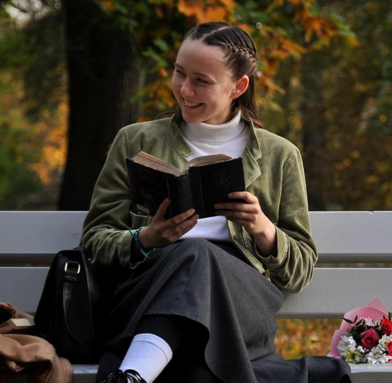 Julita, Latin instructor at AKRO, holding an open book